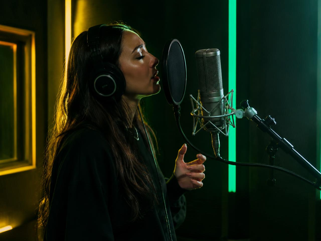 Singer recording vocals in a studio booth